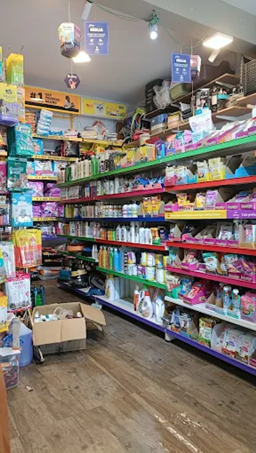Pet shop aisle lined with shelves of pet food, shampoos and care products